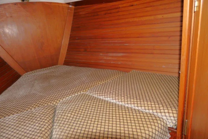 Slide: The Image of Cozy cabin interior of 1984 Wauqueize Hood 38 MK II sailboat with wooden paneling. - 28