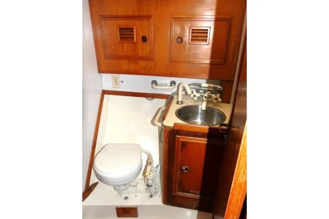 Slide: The Image of 1984 Wauqueize Hood 38 MK II yacht bathroom with wooden cabinets and compact sink. - 29