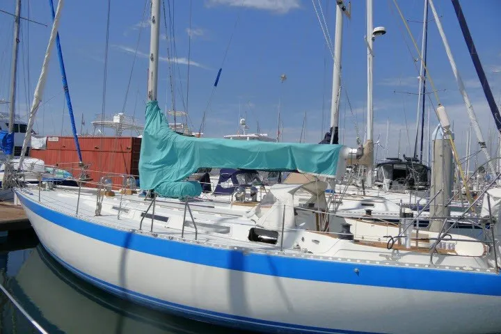 Slide: The Image of 1984 Wauqueize Hood 38 MK II sailboat docked in marina, blue and white hull. - 52