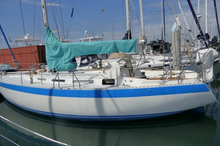 Slide: The Image of 1984 Wauqueize Hood 38 MK II sailboat docked in a marina, blue and white hull. - 51