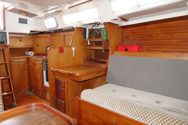 Slide: The Image of Interior of 1984 Wauqueize Hood 38 MK II sailboat with wooden cabinetry and seating area. - 18