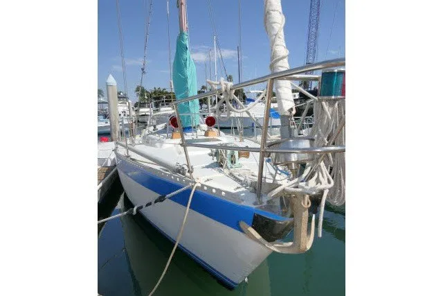 Slide: The Image of 1984 Wauqueize Hood 38 MK II sailboat docked in marina, featuring blue and white hull. - 47