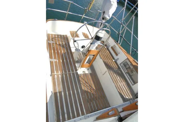 Slide: The Image of Cockpit of 1984 Wauqueize Hood 38 MK II sailboat with wooden seating and steering wheel. - 32