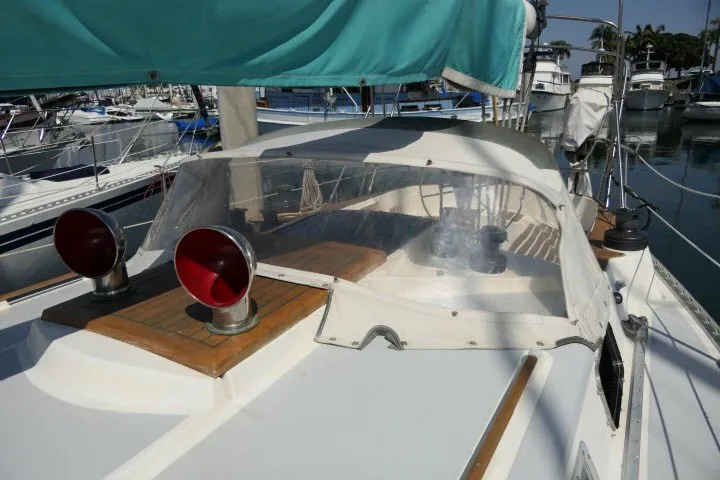 Slide: The Image of 1984 Wauqueize Hood 38 MK II sailboat with clear cockpit cover in marina. - 42