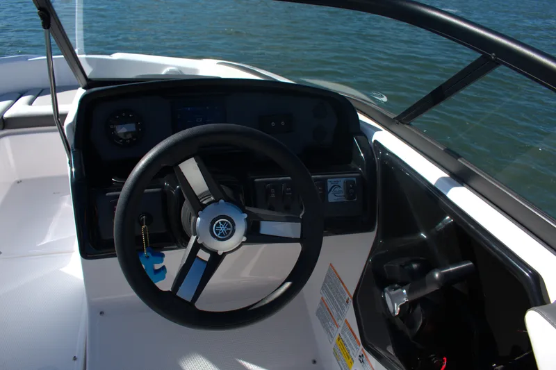 Slide: The Image of Steering wheel and dashboard of 2025 Yamaha Boats AR190 on water. - 10