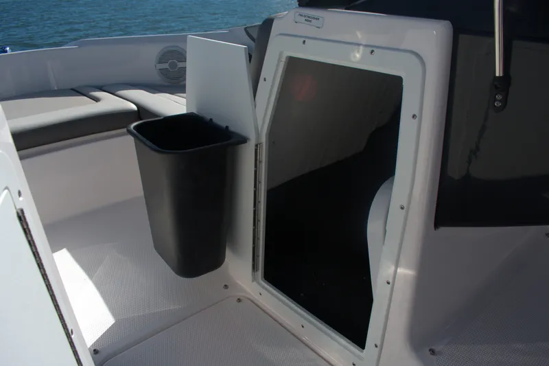 Slide: The Image of Interior of 2025 Yamaha AR190 boat with storage compartment and trash bin. - 19