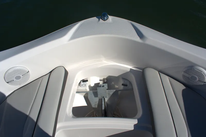 Slide: The Image of 2025 Yamaha Boats AR190 bow seating area with anchor storage and speakers. - 9