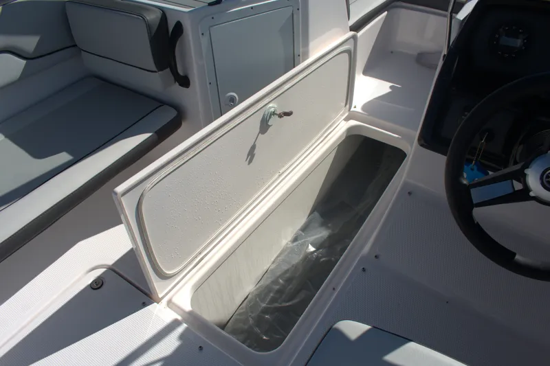 Slide: The Image of 2025 Yamaha Boats AR190 interior storage compartment and seating area. - 15