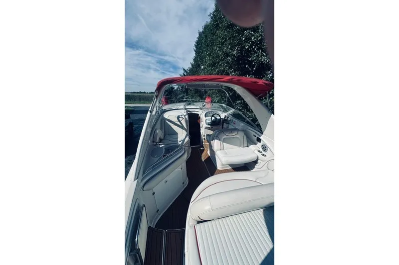 Slide: The Image of 2004 Monterey 298SC Super Sport boat interior with white seating and red canopy. - 7