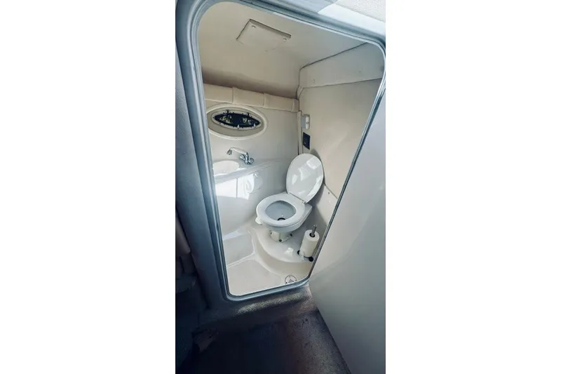 Slide: The Image of Compact bathroom inside a 2004 Monterey 298SC Super Sport boat. - 9