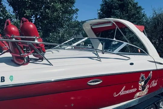 Slide: The Image of 2004 Monterey 298SC Super Sport boat with red accents and safety equipment. - 1