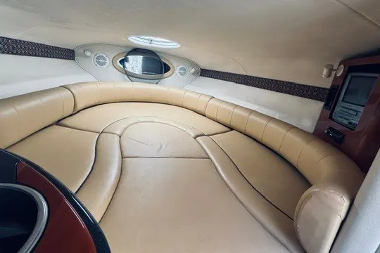 Slide: The Image of Luxurious interior of a 2004 Monterey 298SC Super Sport boat with beige seating. - 8
