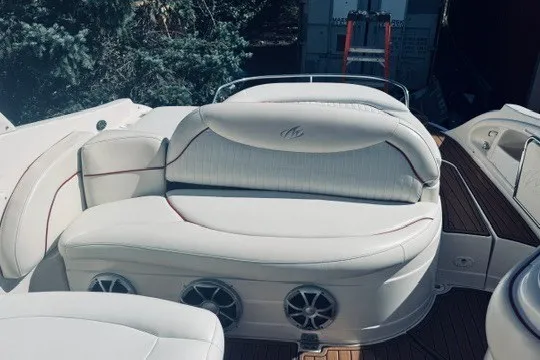 Slide: The Image of 2004 Monterey 298SC Super Sport boat interior with white seating and speaker system. - 5