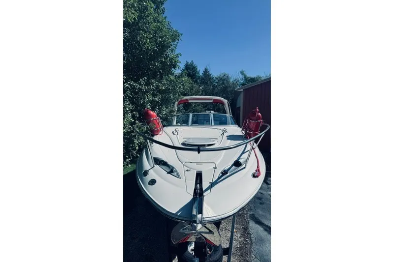 Slide: The Image of 2004 Monterey 298SC Super Sport boat parked outdoors, surrounded by trees. - 13