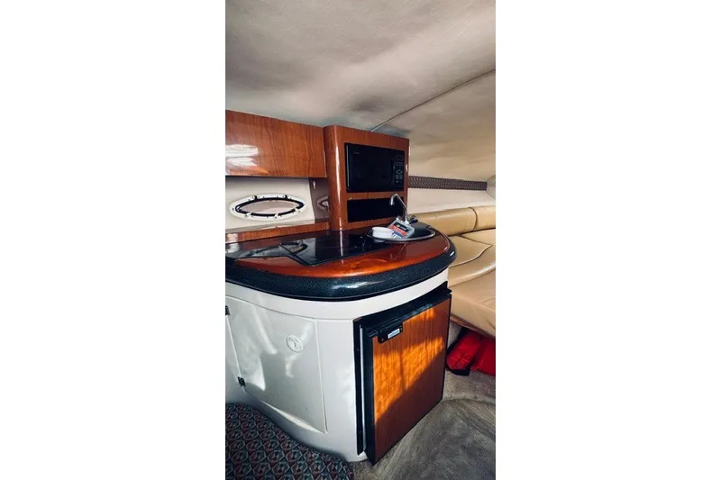 Slide: The Image of Interior of 2004 Monterey 298SC Super Sport boat with kitchenette and seating area. - 11