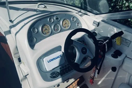 Slide: The Image of Dashboard of a 2004 Monterey 298SC Super Sport boat with steering wheel and gauges. - 4