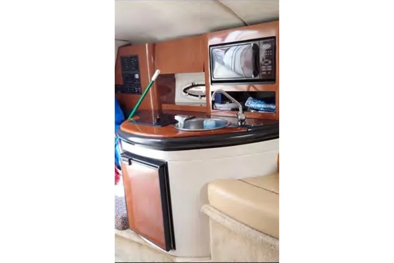Slide: The Image of Interior of 2004 Monterey 298SC Super Sport boat with kitchenette and microwave. - 12