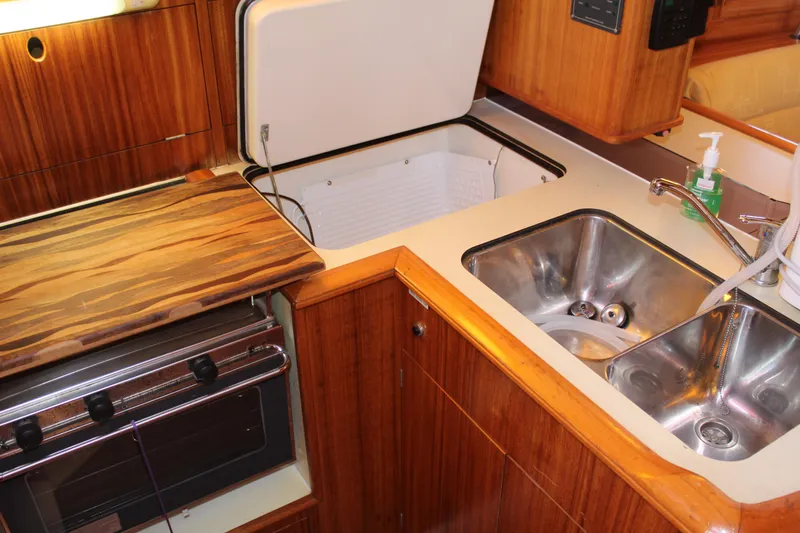 Slide: The Image of 2003 Dufour Gib Sea 37 yacht kitchen with sink, stove, and storage. - 23