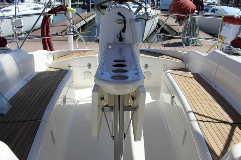 Slide: The Image of Cockpit of 2003 Dufour Gib Sea 37 sailboat with wooden seating and steering console. - 17