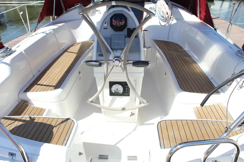 Slide: The Image of Cockpit of 2003 Dufour Gib Sea 37 sailboat with teak seating and steering wheel. - 15