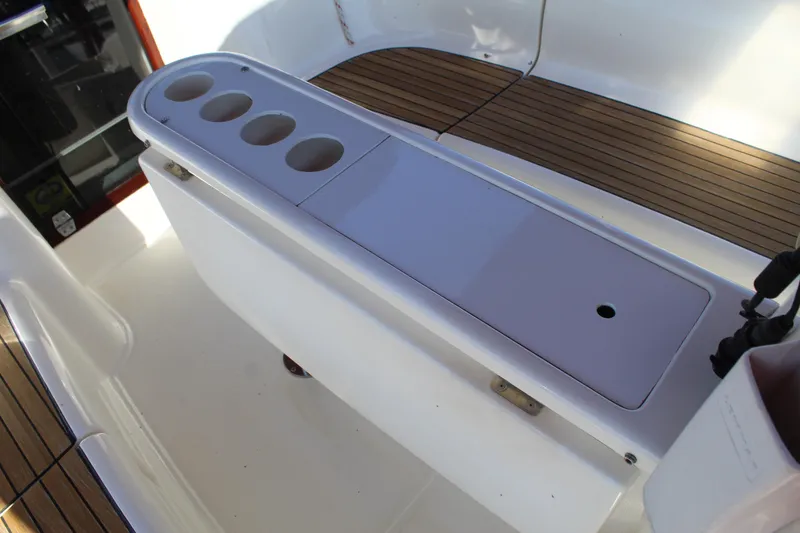 Slide: The Image of Cockpit of 2003 Dufour Gib Sea 37 sailboat with teak flooring and storage compartments. - 19