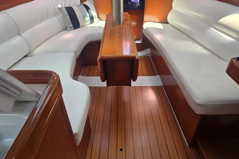 Slide: The Image of Interior of 2006 Beneteau Oceanis 343 yacht with elegant wood flooring and white seating. - 16