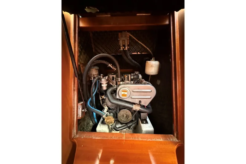 Slide: The Image of Engine compartment of a 2006 Beneteau Oceanis 343 sailboat, showcasing mechanical components. - 26