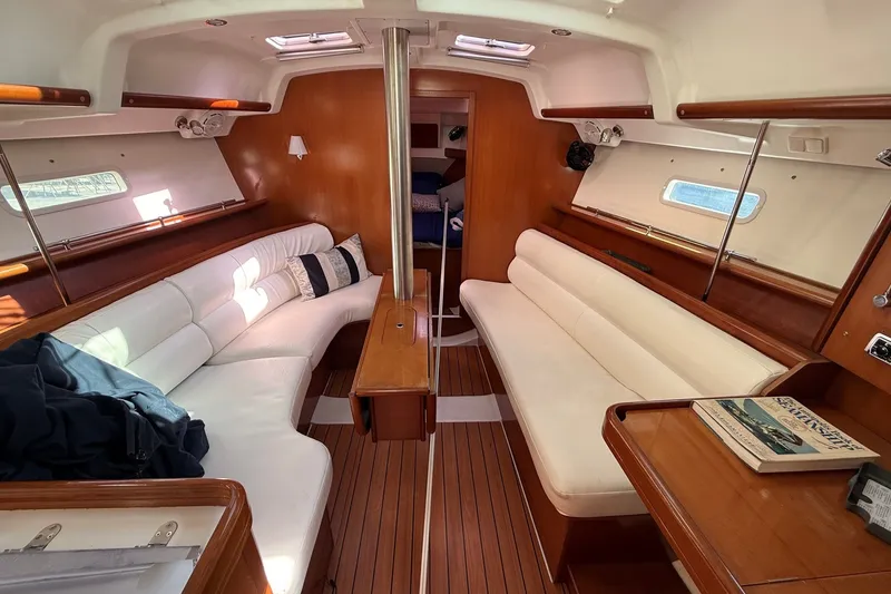 Slide: The Image of Interior of 2006 Beneteau Oceanis 343 sailboat with wooden finish and white seating. - 14