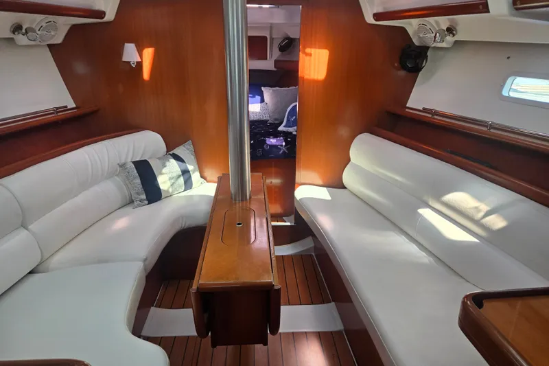 Slide: The Image of Interior of 2006 Beneteau Oceanis 343 sailboat with white seating and wooden accents. - 15