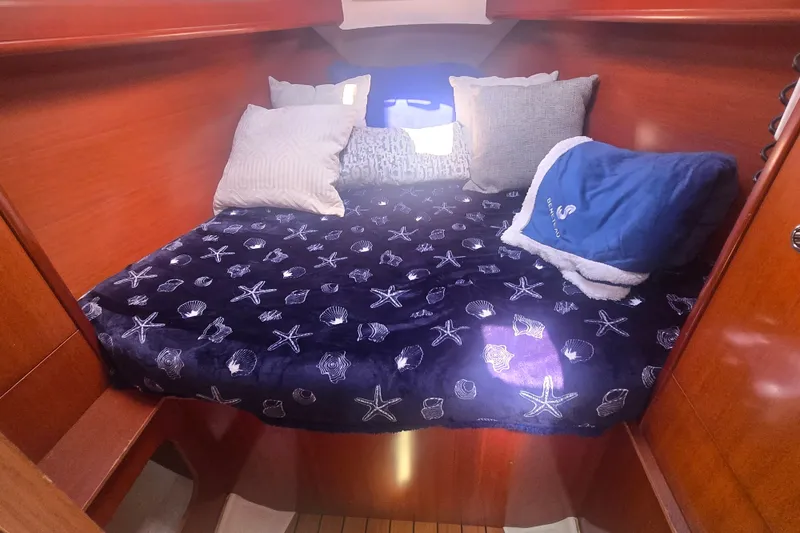 Slide: The Image of Cozy cabin interior of 2006 Beneteau Oceanis 343 with nautical-themed bedding. - 23