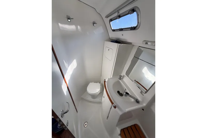 Slide: The Image of Bathroom interior of 2006 Beneteau Oceanis 343 yacht, featuring toilet, sink, and mirror. - 20