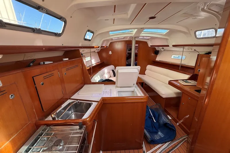 Slide: The Image of Interior of 2006 Beneteau Oceanis 343 sailboat with wood finish and seating area. - 17