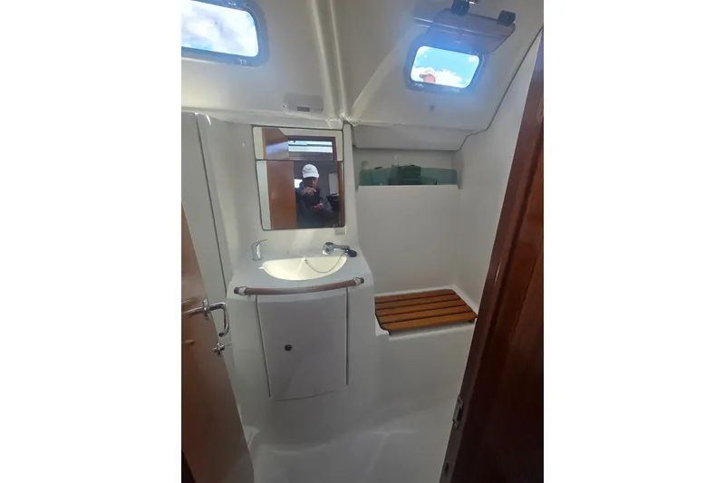 Slide: The Image of Bathroom interior of 2006 Beneteau Oceanis 343 yacht with sink, mirror, and wooden seat. - 21