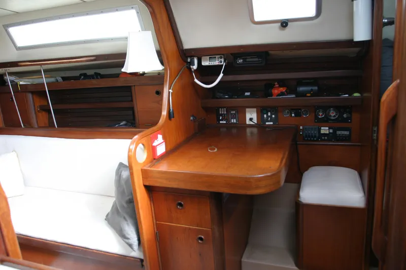 Slide: The Image of Interior of 1983 Beneteau Idylle 11.50 sailboat with wooden furnishings and navigation equipment. - 6