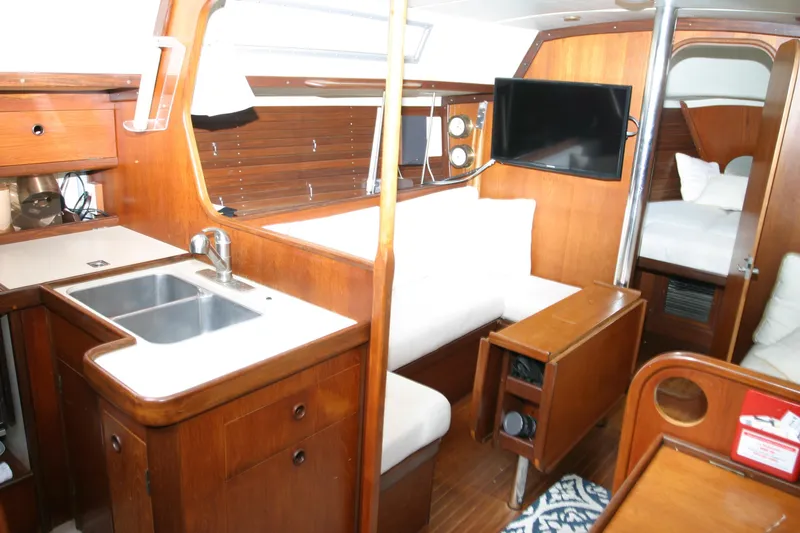 Slide: The Image of Interior of 1983 Beneteau Idylle 11.50 yacht with wood finish and modern amenities. - 4