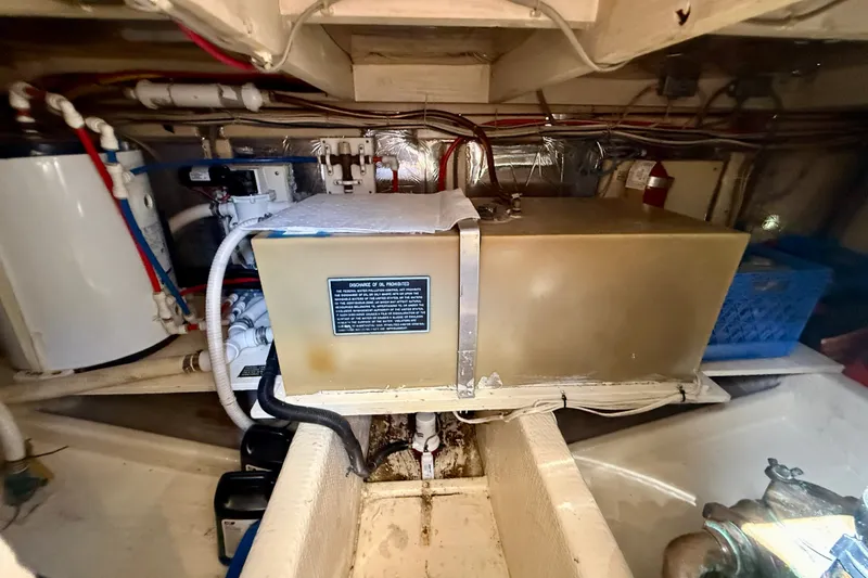 Slide: The Image of Engine room of 1985 Chris-Craft 382 Commander with mechanical components and wiring. - 86