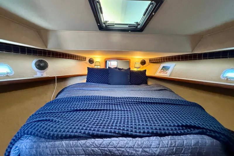 Slide: The Image of Cozy cabin interior of 1985 Chris-Craft 382 Commander with bed and portholes. - 30