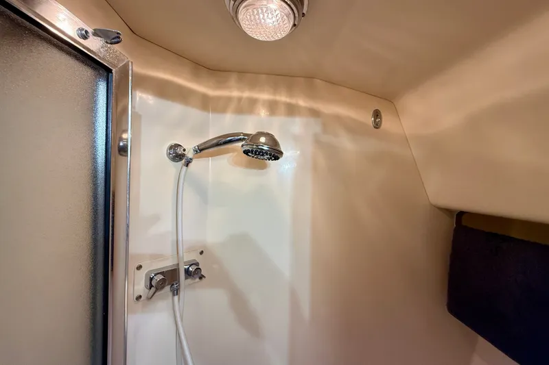Slide: The Image of Shower area in 1985 Chris-Craft 382 Commander yacht, featuring chrome fixtures and lighting. - 38