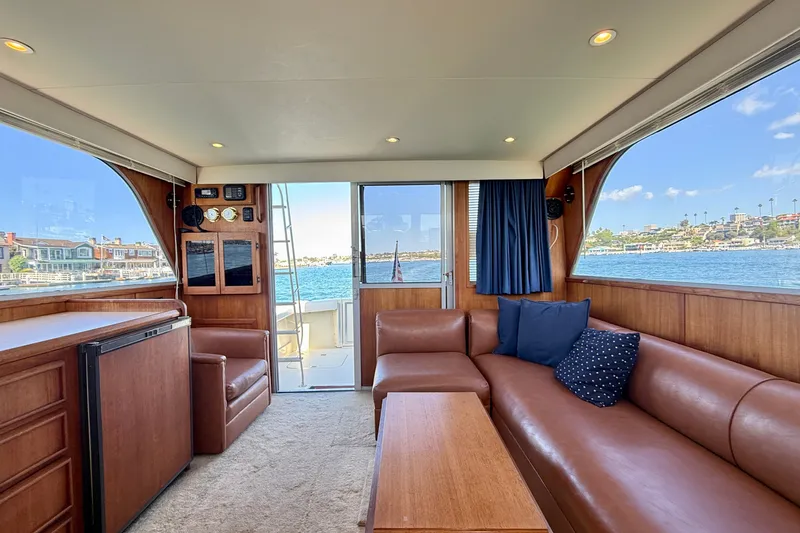 Slide: The Image of Luxurious interior of 1985 Chris-Craft 382 Commander yacht with leather seating and scenic water view. - 18