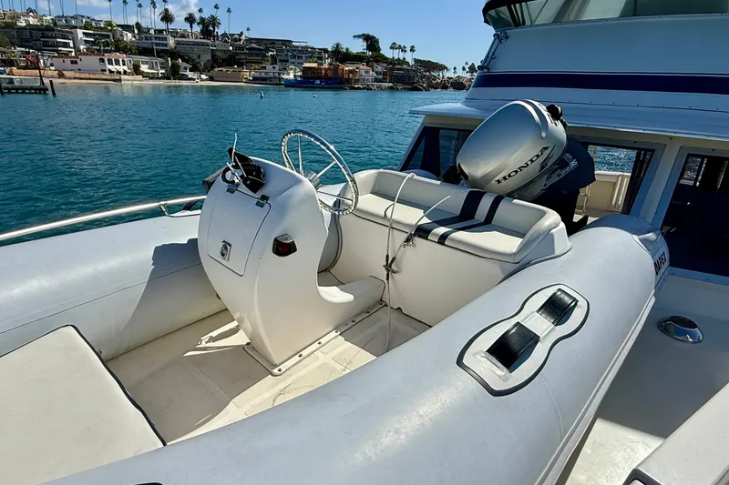 Slide: The Image of 1985 Chris-Craft 382 Commander boat with Honda outboard motor on a sunny day. - 72
