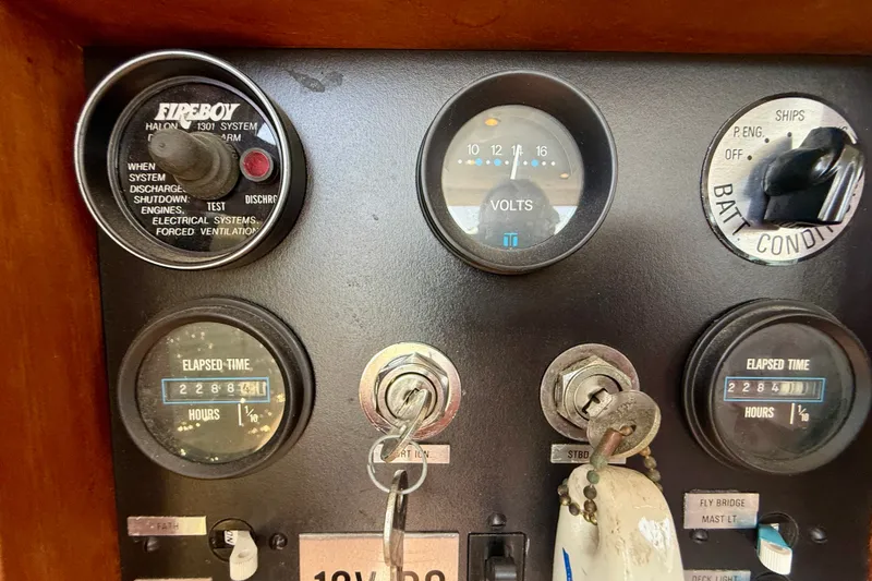 Slide: The Image of Control panel of a 1985 Chris-Craft 382 Commander boat with gauges and ignition keys. - 44