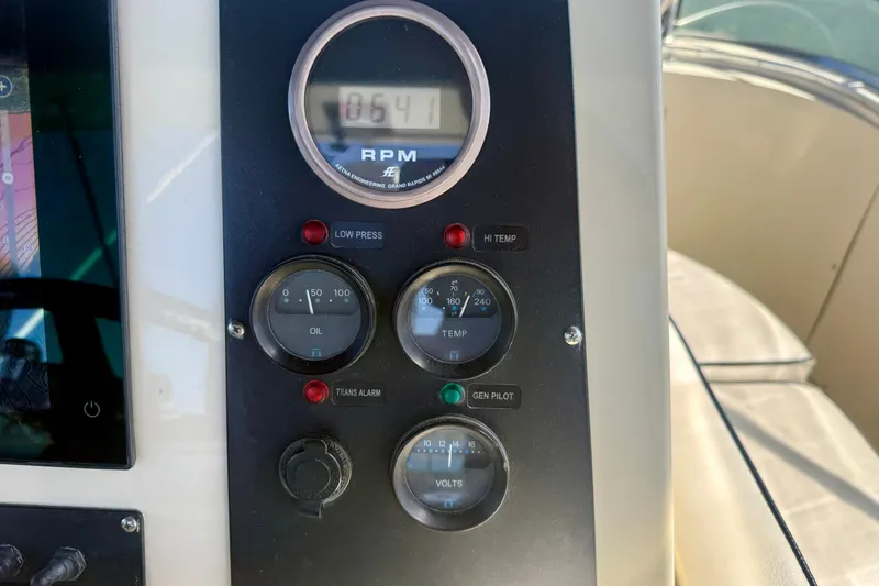 Slide: The Image of Dashboard of a 1985 Chris-Craft 382 Commander boat showing RPM and engine gauges. - 64