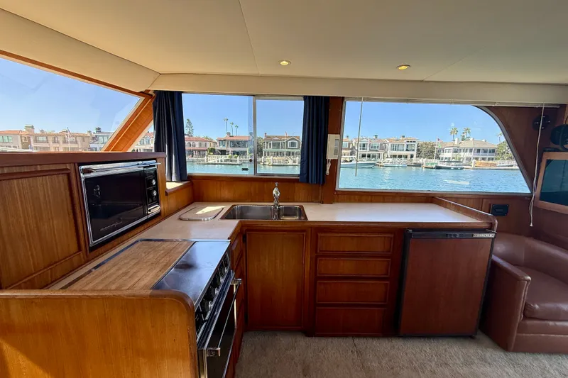 Slide: The Image of Interior of 1985 Chris-Craft 382 Commander yacht with kitchen and waterfront view. - 21