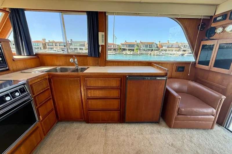 Slide: The Image of Interior of 1985 Chris-Craft 382 Commander yacht with wood cabinetry and waterfront view. - 20