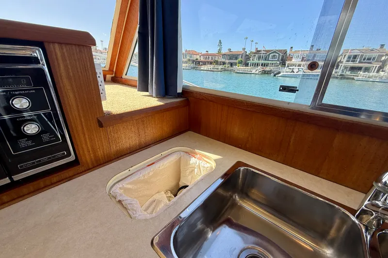 Slide: The Image of Interior of 1985 Chris-Craft 382 Commander with sink and scenic window view. - 27