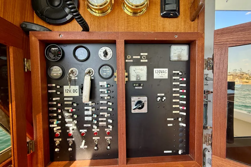 Slide: The Image of Electrical control panel of a 1985 Chris-Craft 382 Commander boat, featuring gauges and switches. - 43
