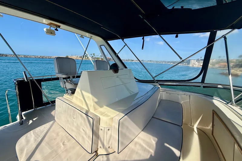 Slide: The Image of 1985 Chris-Craft 382 Commander boat interior with helm, overlooking calm blue waters. - 57