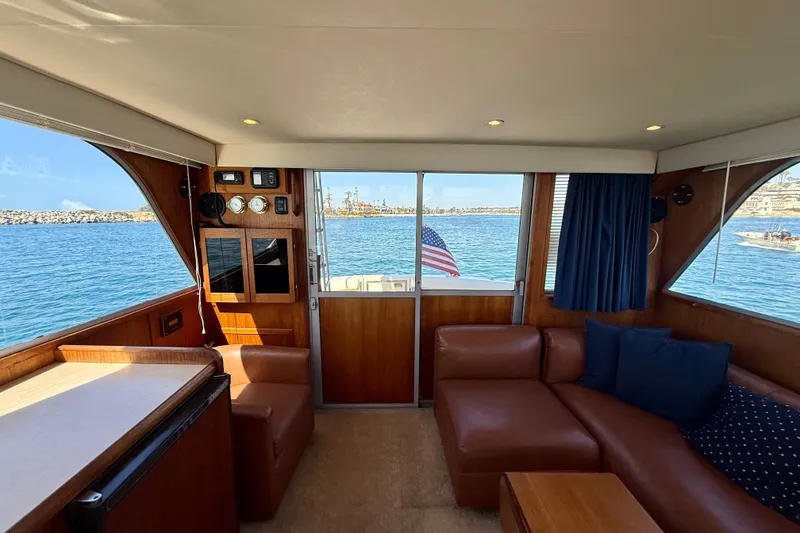 Slide: The Image of Interior of 1985 Chris-Craft 382 Commander yacht with leather seating and ocean view. - 19