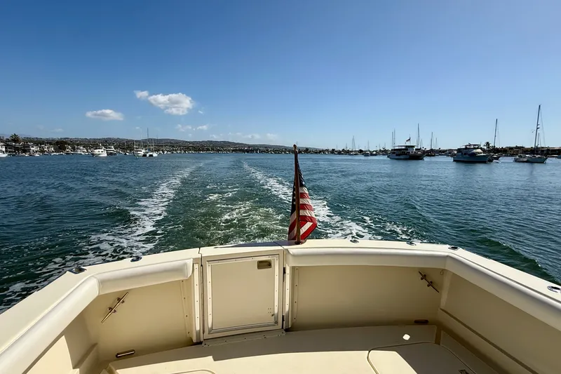 Slide: The Image of 1985 Chris-Craft 382 Commander cruising on a sunny day with American flag. - 88