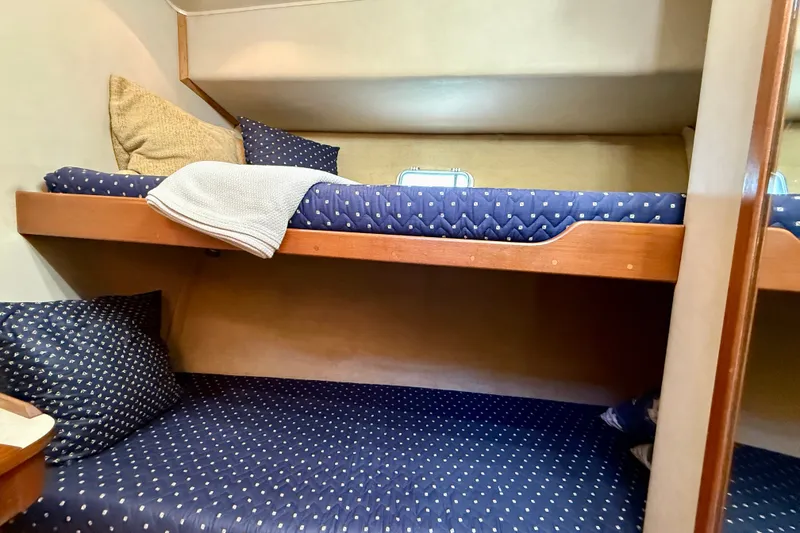 Slide: The Image of Interior of 1985 Chris-Craft 382 Commander with cozy bunk beds and nautical-themed bedding. - 34